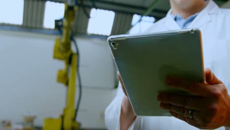 Low-angle-view-of-robotic-engineer-using-digital-tablet-4k