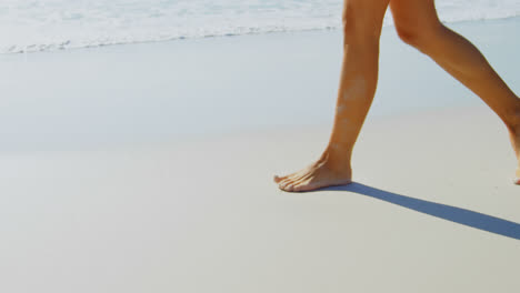Low-section-of-woman-walking-at-beach-on-a-sunny-day-4k