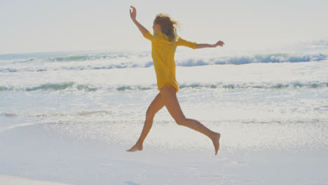 Side-view-of-young-Caucasian-woman-running-on-the-beach-4k