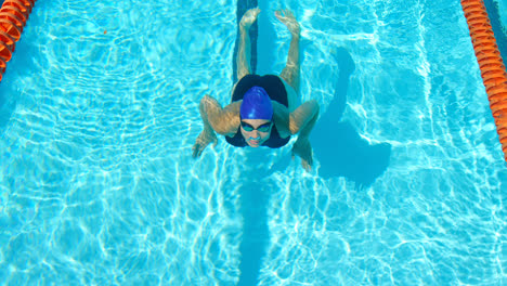 Female-swimmer-swimming-inside-the-pool-4k