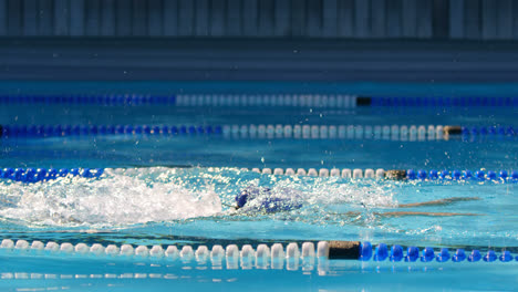 Female-swimmer-swimming-inside-pool-4k