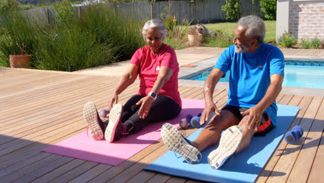 Front-view-of-old-asian-senior-couple-exercising-in-the-backyard-of-their-home-4k