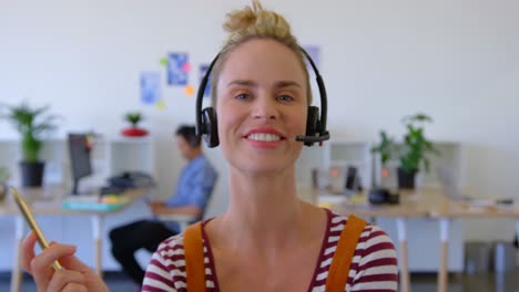Pretty-Caucasian-female-executive-in-headset-sitting-at-desk-4k