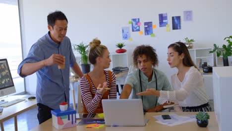 Young-mixed-race-business-people-working-on-laptop-and-interacting-each-others-in-a-office-4k