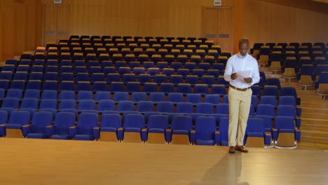 African-American-businessman-practicing-speech-in-empty-auditorium-4k