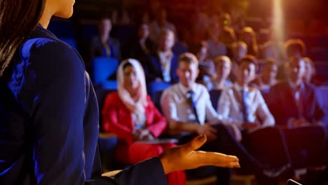Businesswoman-speaking-in-business-seminar-at-auditorium-4k