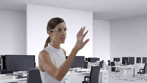Businesswoman-wearing-scientific-glasses-sliding-a-digital-screen-4k