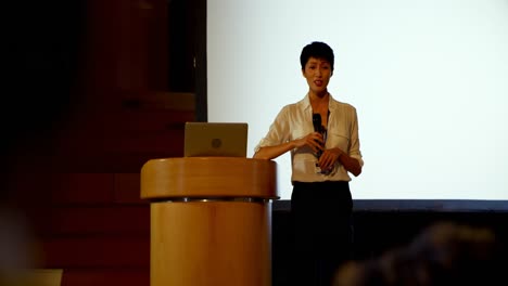 Young-Asian-businesswoman-speaking-in-business-seminar-in-auditorium-4k