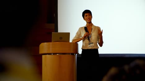 Young-Asian-businesswoman-speaking-in-business-seminar-in-auditorium-4k