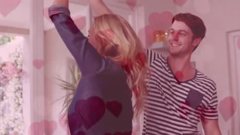Cute-couple-dancing-in-the-living-room-with-hearts-flying