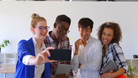 Young-multi-ethnic-business-colleagues-taking-selfie-with-mobile-phone-in-modern-office-4k