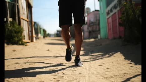 African-American-male-runner-jogging-near-beach-4k