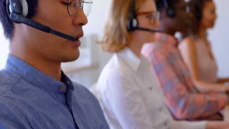 Multi-ethnic-customer-sales-executives-talking-on-headset-in-modern-office-4k