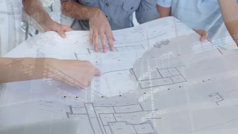 Architects-discussing-blueprints-with-construction-site-