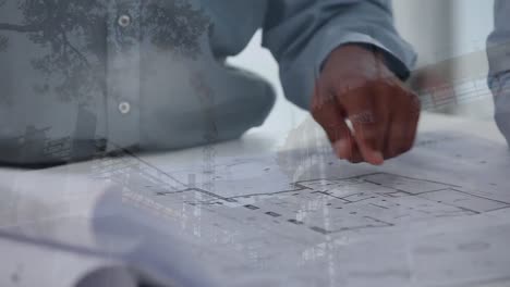 Architects-discussing-over-blueprints-with-construction-site-