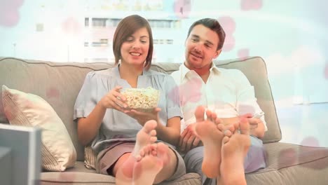 Couple-eating-pop-corn-on-sofa-with-pink-heart-animation