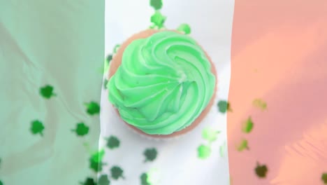 Shamrocks-in-paper-falling-on-a-muffin-against-an-Irish-flag