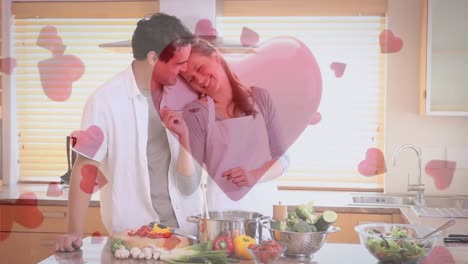Couple-having-fun-and-cooking-at-home-with-digital-hearts