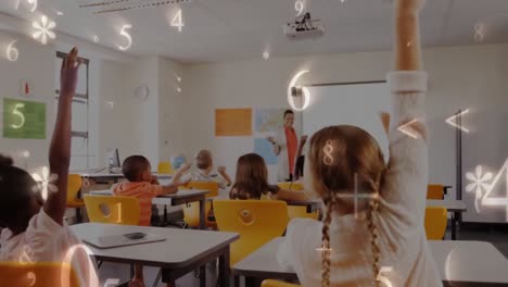 School-children-raising-arms-in-class-with-numbers-on-screen