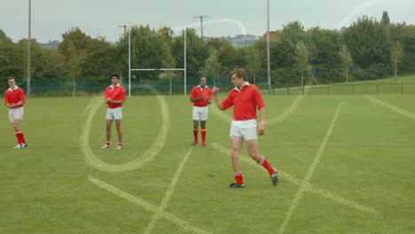 Group-of-multi-ethnic-rugby-players-playing-football-on-football-field.