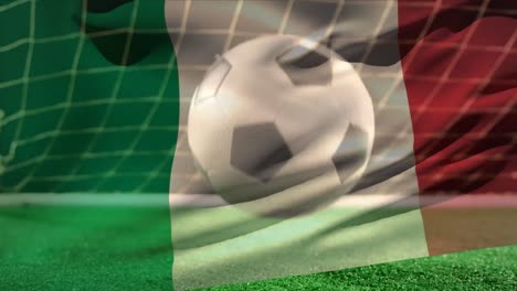 Fútbol-Rebotando-En-El-Suelo-Frente-A-La-Portería-Con-Una-Bandera-Italiana-En-Primer-Plano.