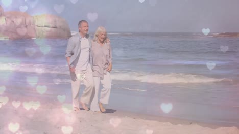 Couple-walking-hand-in-hand-on-beach