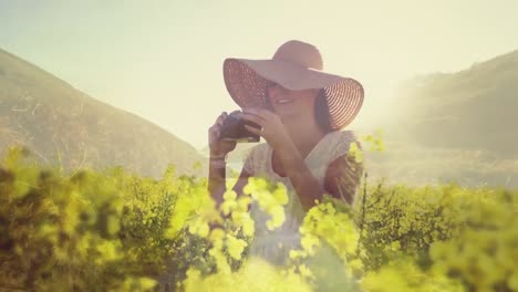Woman-in-a-field-of-flowers-taking-pictures