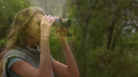 Woman-observing-the-forest-using-binoculars