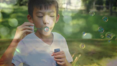 Little-boy-blowing-bubbles-in-the-park