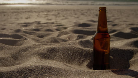 Beer-bottle-on-sand-at-beach-4k