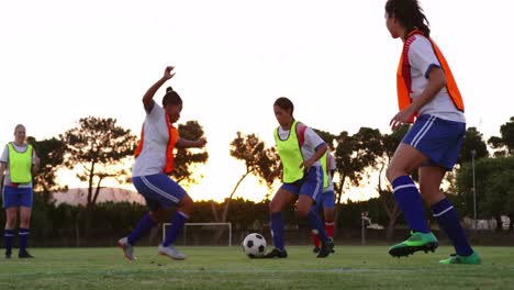 Female-soccer-player-trying-to-tackle-down-another-player-on-soccer-field.-4k