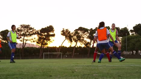 Female-soccer-players-passing-the-ball-while-playing-in-different-teams.-4k