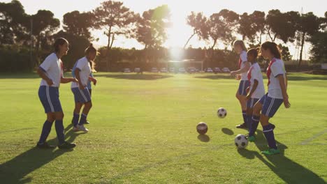 Side-view-of-female-soccer-team-training-4k