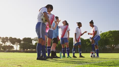 Female-soccer-team-in-break-time-talking-on-soccer-field.-4k