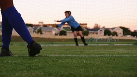 Female-keeper-waiting-for-female-soccer-player-to-kick-the-ball.-4k