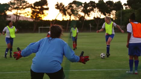 Female-soccer-players-passing-the-ball-while-female-player-falls-down.-4k