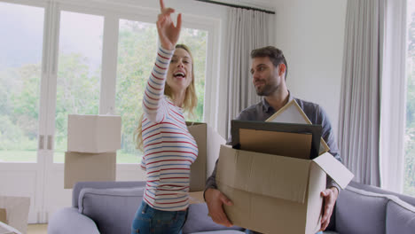Couple-holding-cardboard-boxes-and-interacting-with-each-other-in-new-home-4k