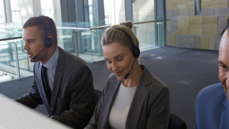 Young-business-people-wearing-headsets-in-a-modern-office