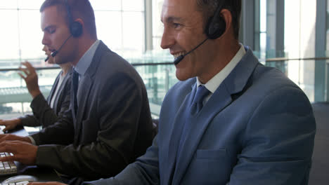 Business-people-wearing-headsets-in-a-modern-office