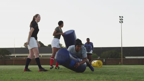 Young-adult-female-rugby-team-training