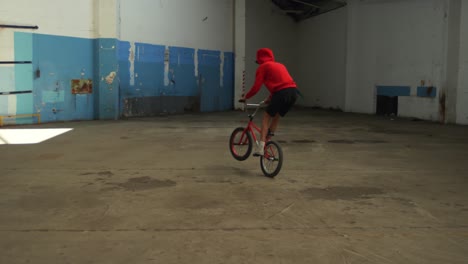 BMX-rider-in-an-empty-warehouse