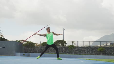 Side-view-of-caucasian-athlete-throwing-javelin
