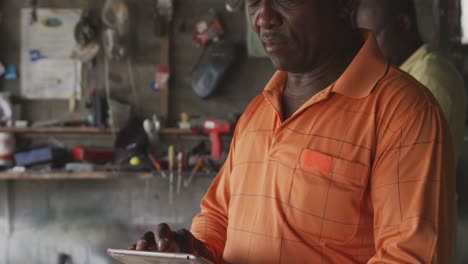 African-man-looking-at-touch-pad-at-work