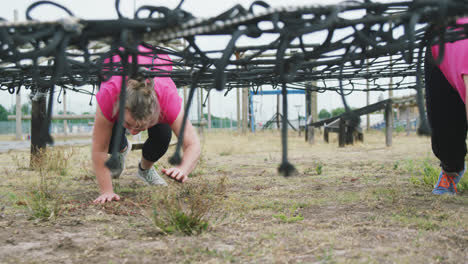 Female-friends-enjoying-exercising-at-boot-camp-together