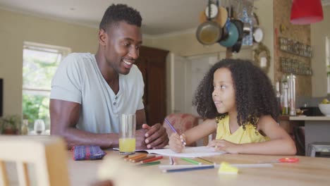 African-american-father-and-daughter-coloring-and-giving-high-five-