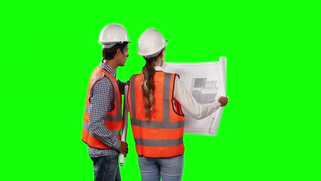 Rear-view-of-site-workers-looking-at-the-site-map-with-green-screen