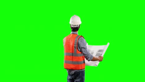 Side-view-of-site-worker-looking-at-a-site-map-with-green-screen