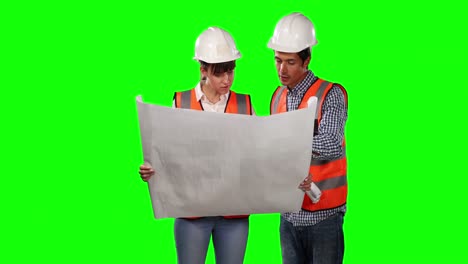 Front-view-of-site-workers-looking-at-site-map-with-green-screen
