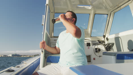 Side-view-of-a-Caucasian-man-on-a-boat-drinking-