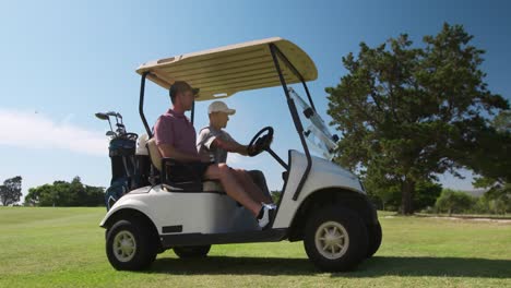 Caucasian-male-golfers-into-a-golf-buggy-